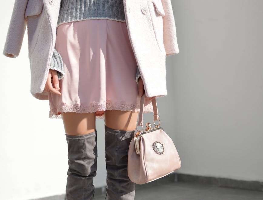 clothing apparel skirt person human handbag accessories bag overcoat coat
